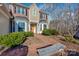 Brick walkway leads to the front door of a two-story house with landscaping at 12749 Netherhall Dr, Charlotte, NC 28269