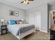 Spacious bedroom with a metal bed frame, nightstands, and ample closet space at 130 W Warfield Dr, Mooresville, NC 28115