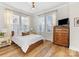 Main bedroom with king-size bed and large windows at 1302 Nandina St, Charlotte, NC 28205