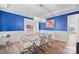 Formal dining room boasts a glass table, stylish white chairs, wainscoting, and a modern chandelier at 13020 Hindcross Dr, Huntersville, NC 28078