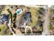 Aerial view of a home with a large yard, mature trees, swimming pool, and circular driveway at 13031 Westmoreland Farm Rd, Davidson, NC 28036