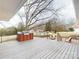 A large wooden deck with a grill, outdoor furniture, a view of the backyard, and mature trees at 13031 Westmoreland Farm Rd, Davidson, NC 28036