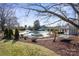 Picturesque backyard with a pool, spa, and outdoor seating areas surrounded by mature trees at 13031 Westmoreland Farm Rd, Davidson, NC 28036