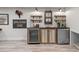 Basement bar area with wine fridge, beverage fridge, and custom cabinetry at 13031 Westmoreland Farm Rd, Davidson, NC 28036