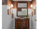 Bathroom vanity with wooden accents, decorative mirror and lighting at 13031 Westmoreland Farm Rd, Davidson, NC 28036