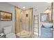 Bathroom featuring tiled shower, modern sink and wooden accents at 13031 Westmoreland Farm Rd, Davidson, NC 28036