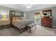 Bedroom with light blue walls, carpeted floors and a large window at 13031 Westmoreland Farm Rd, Davidson, NC 28036