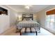 Well lit bedroom with light blue walls, carpeted floors and a window at 13031 Westmoreland Farm Rd, Davidson, NC 28036