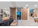 Basement dining area with custom barn doors, aquarium, and wet bar at 13031 Westmoreland Farm Rd, Davidson, NC 28036