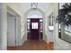 The foyer shows an arched ceiling, hardwood floors, and a dark wood front door with sidelights at 13031 Westmoreland Farm Rd, Davidson, NC 28036