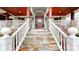 Inviting home entrance with stone steps, white railings, and a charming wood door with sidelights at 13031 Westmoreland Farm Rd, Davidson, NC 28036