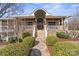 Charming home featuring stone accents, a covered porch, and professionally landscaped front yard at 13031 Westmoreland Farm Rd, Davidson, NC 28036