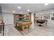 Spacious game room with pool table, bunk beds, and rustic wood columns at 13031 Westmoreland Farm Rd, Davidson, NC 28036