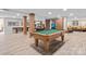 Large game room with pool table, ping pong table, rustic wood columns, and barn-style doors at 13031 Westmoreland Farm Rd, Davidson, NC 28036