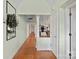 The hallway shows hardwood floors, white trim, and doorways leading to other rooms at 13031 Westmoreland Farm Rd, Davidson, NC 28036