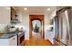 Well lit kitchen with stainless steel appliances and wooden floors at 13031 Westmoreland Farm Rd, Davidson, NC 28036