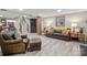 Basement living room with cozy seating, wood-look floors, staircase, and stylish decor at 13031 Westmoreland Farm Rd, Davidson, NC 28036