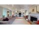 A spacious living room has hardwood floors, a fireplace, and custom shelving at 13031 Westmoreland Farm Rd, Davidson, NC 28036