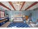 Comfortable pool house interior with a sofa, seating, and playful beach decor at 13031 Westmoreland Farm Rd, Davidson, NC 28036