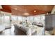 Bright and airy sunroom featuring wood ceilings, ceiling fan, dining table, and comfortable seating area at 13031 Westmoreland Farm Rd, Davidson, NC 28036