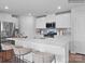 Modern kitchen with white cabinets, a white quartz countertop and gray tile backsplash at 13119 Hampton Bay Ln, Charlotte, NC 28262