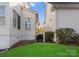 Lush green backyard with stairs leading up to the house, offering a tranquil outdoor space at 14111 Garden District Row, Huntersville, NC 28078