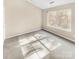 Well-lit bedroom with carpet flooring and a large window at 17015 Greenlawn Hills Ct, Charlotte, NC 28213