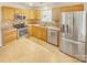 Updated kitchen, featuring stainless steel appliances and wood cabinetry at 17015 Greenlawn Hills Ct, Charlotte, NC 28213