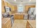 Kitchen features wood cabinets, stainless steel appliances, and tile flooring at 17015 Greenlawn Hills Ct, Charlotte, NC 28213