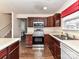 Kitchen with stainless steel appliances and dark wood cabinets at 17105 Greenlawn Hills Ct, Charlotte, NC 28213