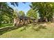 Brick ranch home with green lawn and mature trees at 1935 Berkshire Dr, Gastonia, NC 28052