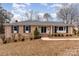 Brick ranch home with black shutters and landscaping at 1935 Berkshire Dr, Gastonia, NC 28052
