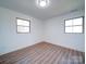 Well-lit bedroom with wood floors and two windows at 2705 Lowell Bethesda Rd, Gastonia, NC 28056