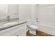 Bright bathroom featuring granite vanity, white toilet, and a tub with shower in a modern-designed home at 3112 Amay James Ave, Charlotte, NC 28208