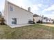 Back exterior view of house showcasing a sliding glass door and a concrete patio at 3521 Goldeneye Dr, Charlotte, NC 28216