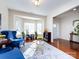 Living room with hardwood floors, two blue wingback chairs, and bay window at 3521 Goldeneye Dr, Charlotte, NC 28216