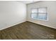 Simple bedroom with hardwood floors and a large window at 3744 Amber Meadows Dr, Charlotte, NC 28269