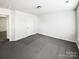Simple bedroom with gray carpet and access to another room at 3744 Amber Meadows Dr, Charlotte, NC 28269