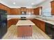 Kitchen with an island, wood cabinets, and stainless steel appliances at 3744 Amber Meadows Dr, Charlotte, NC 28269