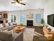 Virtually staged living room with fireplace, hardwood floors, and ample natural light at 3744 Amber Meadows Dr, Charlotte, NC 28269