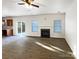 Living room with fireplace, hardwood floors, and sliding glass doors to patio at 3744 Amber Meadows Dr, Charlotte, NC 28269