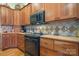 Bright kitchen features wood cabinets, tile backsplash and modern appliances at 4530 Meandering Way, Conover, NC 28613