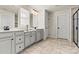 Double vanity bathroom with gray cabinets and tiled floor at 6270 Durango Way, Denver, NC 28037