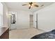 Well-lit bedroom with mirror and door to hallway at 6270 Durango Way, Denver, NC 28037