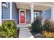 Red front door entrance with stone accents and landscaping at 6270 Durango Way, Denver, NC 28037