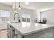 Modern kitchen with white cabinets, an island, and a view from the window at 6270 Durango Way, Denver, NC 28037