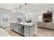 Modern kitchen with white cabinets, island, and stainless steel appliances at 6270 Durango Way, Denver, NC 28037