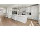 Modern kitchen with white cabinets, stainless steel appliances, and an island at 6270 Durango Way, Denver, NC 28037