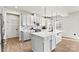 Modern kitchen with white cabinets, an island, and stainless steel appliances at 6270 Durango Way, Denver, NC 28037