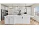 Modern kitchen with white cabinets, stainless steel appliances, and an island at 6270 Durango Way, Denver, NC 28037